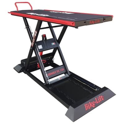 Black powder coated. Max load: 750kg; Lift weight: 260kg; Min height: 20cm; Max height: 130cm; Table top: 220cm long x 75cm wide; Table top with side wings: 220 long x 92cm wide; Side wings: 212cm long x 8.5cm wide; Rear slide-away drop gate panel: 60cm long x 36cm wide; Overall dimensions: 230cm x 92cm; Run-up ramp: 82 x 51cm. 
Professional scissor style motorcycle lift for workshops. Comes with a 230V electric operated hydraulic pump with a wired remote control for easy & dependable control with built-in magnet for easy storage on the lift. A slide-away rear drop gate panel of 60cm long x 36cm wide allows easy access to the rear wheel. Full table top length is 220cm long x 75cm wide without side wings. The side wings are 212cm long x 8.5cm wide and run on both sides over its full length for easy momentary storage of nuts, bolts and other small parts. The lift comes with safety locking positions in 8 different heights and a removable front safety bar to prevent over-shooting the lift when rolling on the bike.