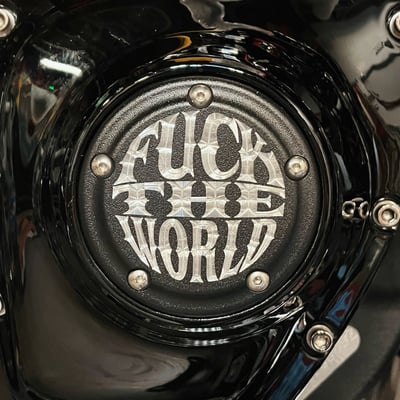 With a matte black powder coated / clear finish. 
With the 'Fuck The World' logo prominently CNC etched allowing the Indian Larry freedom vibe to resonate in this original Indian Larry timing cover.