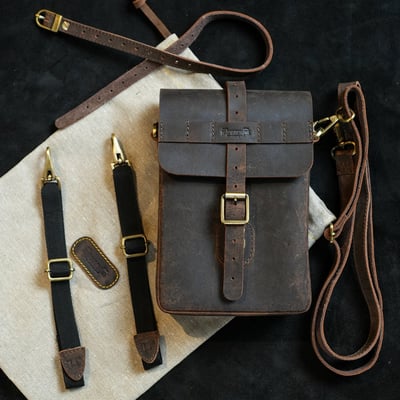 The Trip Machine Moto Sling bag is inspired from the iconic map cases used in WW II. Handcrafted from 2.2 mm thick heavy-duty leather, with a capacity of 1.9 L, the bag is built like a tank, to serve you for decades. It feels at home while on the motorcycle as well as when off it. The versatile quick release mounts allow it to go on every motorcycle and lets you mount or unmount it in under 30 seconds. Perfect for everyday rides, this bag is as dependable, timeless and comes with a rain cover to keep your valuables dry.