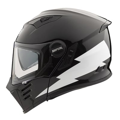 The brand new Simpson Darksome represents the modern expression of an iconic design. This flip-up reminds of the 70’s unique Simpson design, but noise reduction and aerodynamics has been substantially improved. A solid mechanism locks the chinbar in place. The shell features Maxx‐3C tricomposite technology and a lighter, full carbon version is available. The enlarged field of view provides a limit- less vertical and peripheral vision. The drop-down sun visor covers the whole field of view. Features removable and washable inner lining, ready for easy installation of Bluetooth headsets, ECE 22.06 certified. Available in several colors.