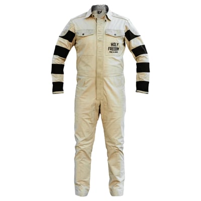 The Tutocrema from Holy Freedom is more than a one-piece suit. It's the official Holy Freedom crew uniform, built for riders who live in the fast lane. Made from stretch cotton twill for all-day mobility, it features vintage-style treatment, striped fabric sleeve inserts, and bold embroidery that hits hard on both chest and back. Leather panels at the shoulders and elbows add abrasion resistance and attitude, while a central leather windproof flap keeps the elements in check. With front patch pockets, trouser pockets, and snap-adjustable sides, it's got the utility you need and the style you can't fake. Zip it, snap it, ride it, this suit doesn't sit still.

• 80% gabardine cotton 20% leather
• stretch and light gabardine cotton
• leather shoulder and elbow inserts
• vintage treatment all over the garment
• sleeves with striped fabric inserts
• technical wrists; zip + snap closure
• embroidery on the chest and large on the back
• front patch pockets + 2 trouser pockets
• adjustment with snaps on the sides
• central leather windproof flap
• the official Crew HolyFreedom tracksuit!