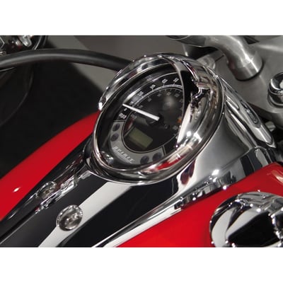 Attaches to tank-mounted speedometers. This half-mooned visor, made of cast metal, blocks the sun's glare from the speedometer glass to make it easier to read the speedometer. The visor has a quality chrome finish. It secures with a self adhesive tape.
