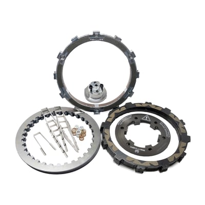 A high performance centrifugal operated clutch that is racing compatible. The big advantage over other performance clutches? You will never again have to pull the clutch when in heavy traffic or when waiting for that traffic light that refuses to turn green. Otherwise, there's no difference with a regular clutch. When the engine revs increase the clutch automatically engages, after that it turns to a regular clutch. The 'engage' RPM is adjustable and a 'how to' tuning card is included. The clutch comes at 'medium setting'. Settings available are 'Low' (< 850 RPM), 'Medium' (850-1050 RPM), 'High' (1050-1150 RPM) and 'Very High' (> 1150 RPM). Above these RPMs you will keep a full functional clutch lever, shifting requires pulling the clutch just like a regular clutch. The clutch only disengages below a certain RPM giving you take off and stops in gear, without using the clutch lever and preventing accidental stalls. This clutch system was initially developed for motocross/dirt bike/adventure bikes, only to prevent nasty accidental stalls in rough terrain, so the rider can have full focus on bike, trail and racing. On the street circumstances may differ, but it works equally well and when navigating in heavy traffic it is a blessing. No modifications are required to OEM parts. The Rekluse sleeves eliminate basket wear and notching. The TorqDrive system allows more discs in less space, totalling to 6 additional friction disks over stock. These friction plates provide up to 50% more clutch hold capacity, all without using stronger springs or a special lock-up device.