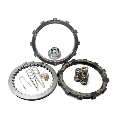 A high performance centrifugal operated clutch that is racing compatible. The big advantage over other performance clutches? You will never again have to pull the clutch when in heavy traffic or when waiting for that traffic light that refuses to turn green. Otherwise, there's no difference with a regular clutch. When the engine revs increase the clutch automatically engages, after that it turns to a regular clutch. The 'engage' RPM is adjustable and a 'how to' tuning card is included. The clutch comes at 'medium setting'. Settings available are 'Low' (< 850 RPM), 'Medium' (850-1050 RPM), 'High' (1050-1150 RPM) and 'Very High' (> 1150 RPM). Above these RPMs you will keep a full functional clutch lever, shifting requires pulling the clutch just like a regular clutch. The clutch only disengages below a certain RPM giving you take off and stops in gear, without using the clutch lever and preventing accidental stalls. This clutch system was initially developed for motocross/dirt bike/adventure bikes, only to prevent nasty accidental stalls in rough terrain, so the rider can have full focus on bike, trail and racing. On the street circumstances may differ, but it works equally well and when navigating in heavy traffic it is a blessing. No modifications are required to OEM parts. The Rekluse sleeves eliminate basket wear and notching. The TorqDrive system allows more discs in less space, totalling to 6 additional friction disks over stock. These friction plates provide up to 50% more clutch hold capacity, all without using stronger springs or a special lock-up device.