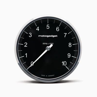 Black with Polished Bezel. 
On this Chronoclassic 'Tacho Face' the large classic needle indicates RPM. Speed & all other functions are shown digitally in red LED's. 
When switched off only the black face is visible, for a perfect classic look. The digital display, an in-house development by Motogadget, consists of a matrix of 512 tiny, super-bright red LEDs that shines through the dial when activated. 
The digital display has two lines. The top line shows the gear and speed/RPM and the bottom line shows the display values, which can be changed at the touch of a button. The illuminated pointer, perfectly illuminated backlight and an automatic brightness adjustment of the matrix LEDs for optimum readability in direct sunlight all the way to in the dark. 
Note: For non-fuel injected motorcycles a Motoscope Breakout Box is required to run the indicator lights. Available as 930311 H-D J1850 and 936577 Breakout Box A / 936578 Breakout Box B for universal applications. 
- Dimensions: 80mm diameter x just 22mm deep
- 11 indicator lights: Immobilizer / alarm (Plug & Ride only), Reserve, Oil temperature / water temperature, engine control / MIL / ABS / ASR (Plug & Ride only), oil pressure, turn signal left, turn signal right, high beam, neutral, universal warning light
- Compatible with CAN-bus vehicles 
- White illuminated pointer / needle 
- Shift light adjustable 0-20.000 RPM 
Digital display: 
- Gear indicator 
- Speed 999 [km/h/mph] 
- Trip A 999.9 [km/mi] 
- Trip B 999.9 [km/mi] 
- Odometer 999999 [km/mi] 
- Oil temperature 0-200 [°C / °F] 
- Water temperature 0-200 [°C/°F] 
- Air temperature -20 - 100 [°C/°F] 
- Oil pressure 0 - 10.0 [bar/psi] 
- Operating hours counter 9999 [h] 
- Travel time [hour/minutes/seconds] 
- Clock
- Time 0-100 km/h - 0 to 99.99 s 
- Acceleration 0 - 2.00 [G] 
- Average speed 999 [km/h/mph] 
- Maximum speed 999 [km/h/mph] 
- Maximum positive acceleration 0 - 2.00 [G] 
- Maximum negative acceleration 0 - 2.00 [G] 
- Maximum RPM digital 20.000 RPM 
- On-board voltage 9V - 18V 
- Fuel gauge 0% - 100% 
Adjustable warning messages: 
- Oil temperature 
- Water temperature 
- On-board voltage 
- Air temperature 
- Oil pressure 
- Tank capacity 
- Service interval 
- Speed warning (gear shift flash) 
Chromeclassic 2 includes: 
- Instrument with 75 cm connection cable & plug connection 
- Cable fuse 
- Speedometer sensor with 150 cm connection cable & two magnets 
- Mini push button 
- Stainless steel mounting screws 
- QR code for mounting and operating instruction 
