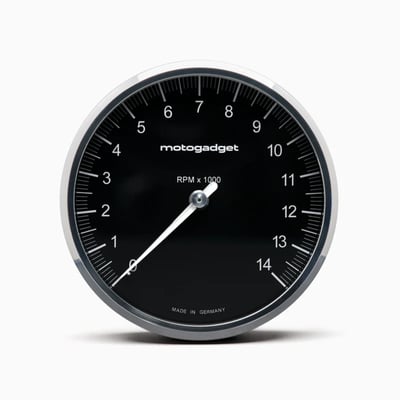 Black with Polished Bezel. 
On this Chronoclassic 'Tacho Face' the large classic needle indicates RPM. Speed & all other functions are shown digital in red LED's. 
When switched off only the black face is visible, for a perfect classic look. The digital display, an in-house development by Motogadget, consists of a matrix of 512 tiny, super-bright red LEDs that shines through the dial when activated. 
The digital display has two lines. The top line shows the gear and speed/RPM and the bottom line shows the display values, which can be changed at the touch of a button. The illuminated pointer, perfectly illuminated backlight and an automatic brightness adjustment of the matrix LEDs for optimum readability in direct sunlight all the way to in the dark. 
Note: For non-fuel injected motorcycles a Motoscope Breakout Box is required to run the indicator lights. Available as 930311 H-D J1850 and 936577 Breakout Box A / 936578 Breakout Box B for universal applications. 
- Dimensions: 80mm diameter x just 22mm deep
- 11 indicator lights: Immobilizer / alarm (Plug & Ride only), Reserve, Oil temperature / water temperature, engine control / MIL / ABS / ASR (Plug & Ride only), oil pressure, turn signal left, turn signal right, high beam, neutral, universal warning light
- Compatible with CAN-bus vehicles 
- White illuminated pointer / needle 
- Shift light adjustable 0-20.000 RPM 
Digital display: 
- Gear indicator 
- Speed 999 [km/h/mph] 
- Trip A 999.9 [km/mi] 
- Trip B 999.9 [km/mi] 
- Odometer 999999 [km/mi] 
- Oil temperature 0-200 [°C / °F] 
- Water temperature 0-200 [°C/°F] 
- Air temperature -20 - 100 [°C/°F] 
- Oil pressure 0 - 10.0 [bar/psi] 
- Operating hours counter 9999 [h] 
- Travel time [hour/minutes/seconds] 
- Clock
- Time 0-100 km/h - 0 to 99.99 s 
- Acceleration 0 - 2.00 [G] 
- Average speed 999 [km/h/mph] 
- Maximum speed 999 [km/h/mph] 
- Maximum positive acceleration 0 - 2.00 [G] 
- Maximum negative acceleration 0 - 2.00 [G] 
- Maximum RPM digital 20.000 RPM 
- On-board voltage 9V - 18V 
- Fuel gauge 0% - 100% 
Adjustable warning messages: 
- Oil temperature 
- Water temperature 
- On-board voltage 
- Air temperature 
- Oil pressure 
- Tank capacity 
- Service interval 
- Speed warning (gear shift flash) 
Chromeclassic 2 includes: 
- Instrument with 75 cm connection cable & plug connection 
- Cable fuse 
- Speedometer sensor with 150 cm connection cable & two magnets 
- Mini push button 
- Stainless steel mounting screws 
- QR code for mounting and operating instruction 
