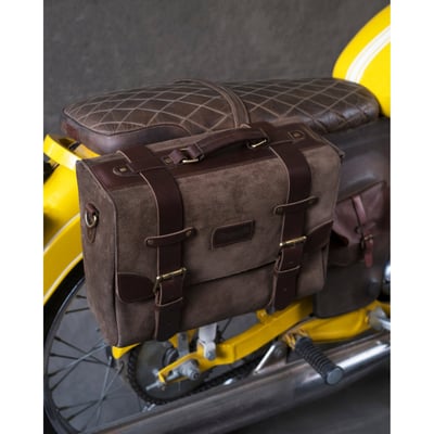 Probably the toughest bag that you'll ever own. Use it and forget it. Made from special dust and water repellant genuine leather suede for any situation. Handmade with the build quality, and charm, of the good old days. Designed for easy on/off the motorcycle in a matter of seconds. Carry it with you when you are not riding by slipping it over your shoulder with the included shoulder strap. Contains a laptop compartment and 3 small pockets to carry your essentials. 100% leather, no cloth, rubber or plastics. 
Approximate dimensions: 15" (38cm) long x 11" (28cm) high x 5" (12.7cm) wide