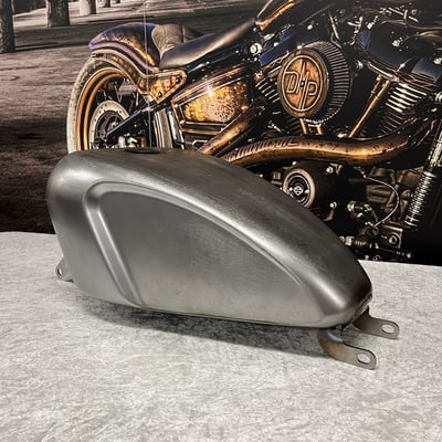 With the design based on a stretched Sporty fuel tank, with Indian Larry influences, this fuel tank is ready to provide stunning looks on your M8 Softail. Supplied in uncoated steel and ready to take the paint scheme of your choice. Installation is a straight forward Plug & Play solution. Complete with installation hardware.  
Note: Works with most stock and aftermarket seats on FXBB, FXBBS, FXST models. 
Mote: Some models require seat modification and/or dash relocation. 
Note: Requires the use of a XL Sportster style gas cap, like 505111 or similar. 
Note: It is always advised to pressure test, seal and test fit all tanks before tanks are painted and installed.