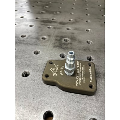 This is an intake test plate, complete with air fitting. Used to make sure you don't have intake leak issues. The test plate bolts to the intake manifold, make sure to collapse the intake pushrods, and use a vacuum hand pump to see if the system holds vacuum. If the system doesn't hold 10 inHG for 10 seconds or longer, you have a leak that you need to deal with. You can then switch over to positive air pressure to more easily find the leak. USA made. 